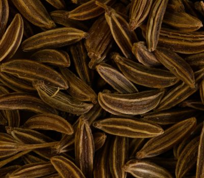 Detailed close-up of brown caraway seeds, ideal for spice and culinary themes. Perfect for food-related content.
